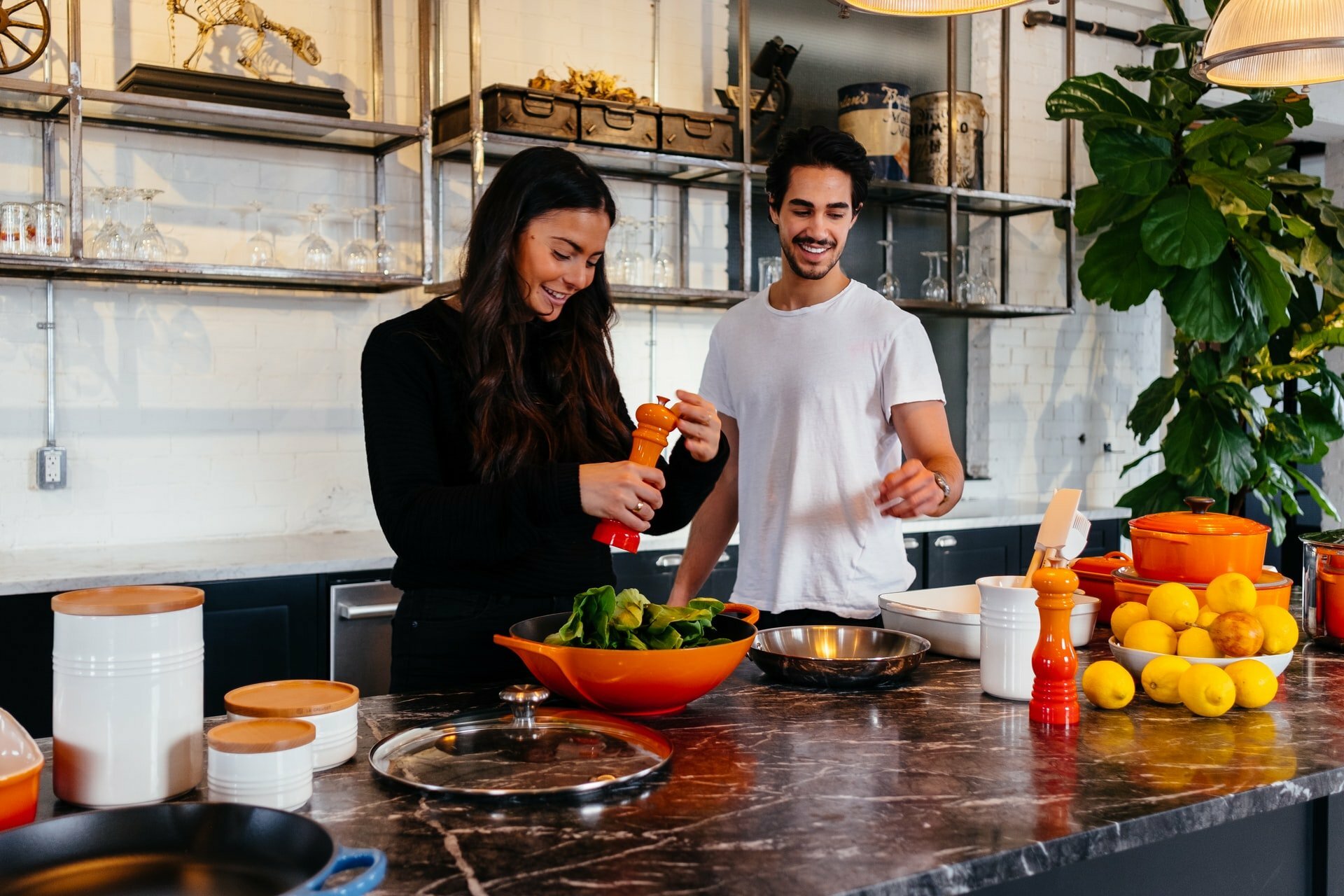 a man and woman in a kitchen