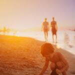 a group of people walking on a beach
