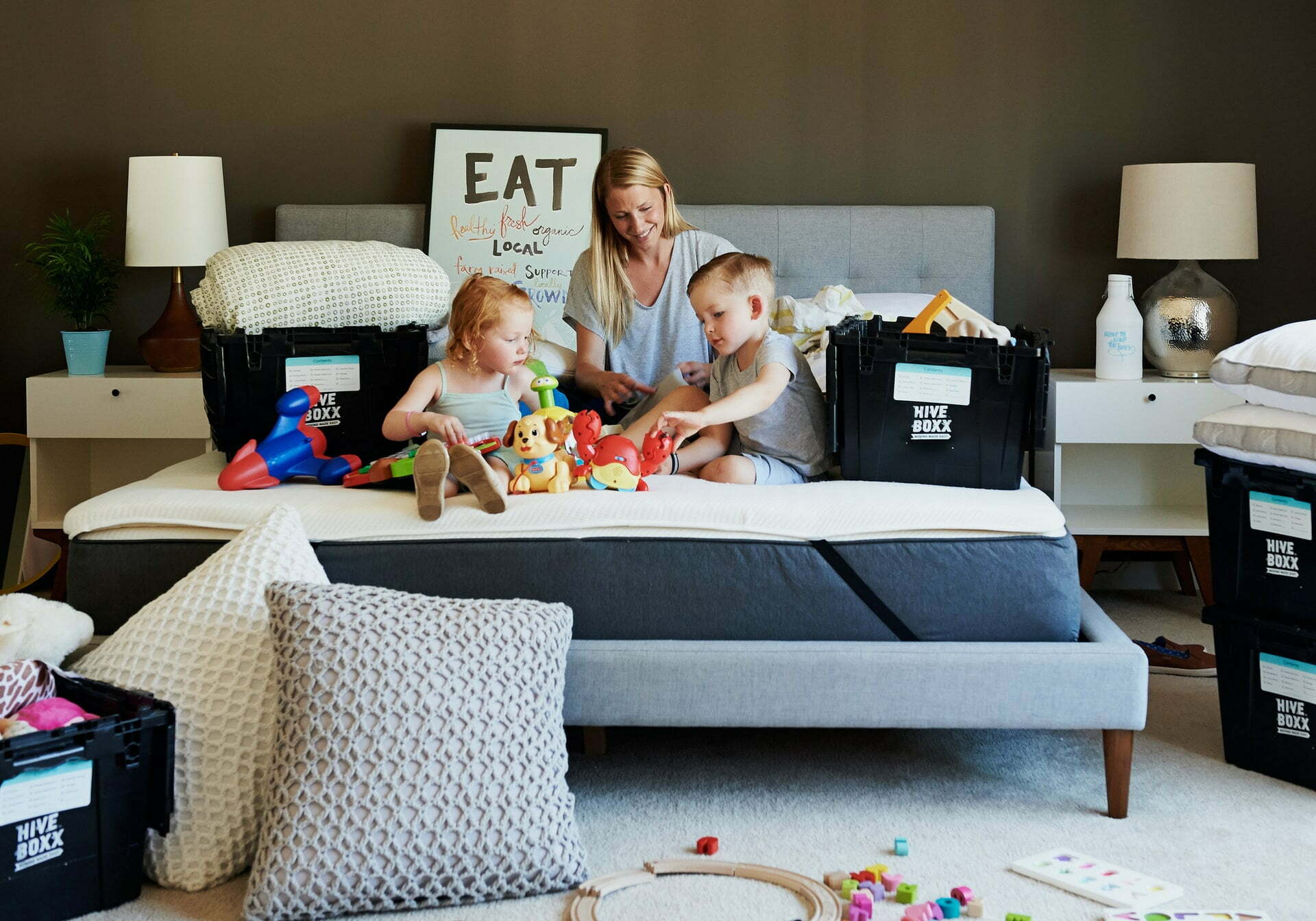 a person and two children on a bed