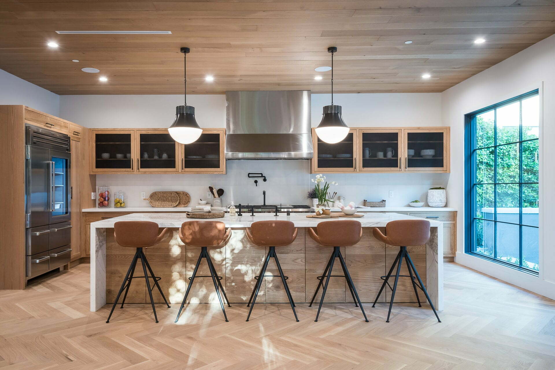 a kitchen with a bar stools and a table