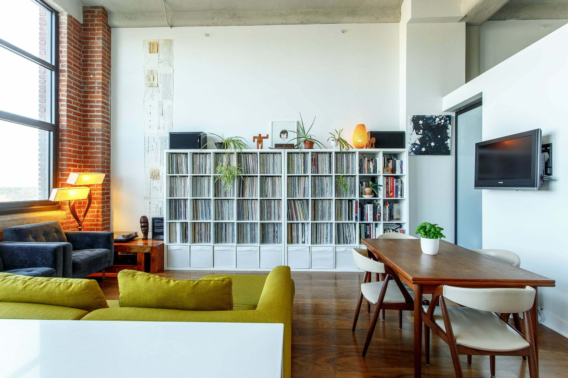 a room with a table and bookshelves