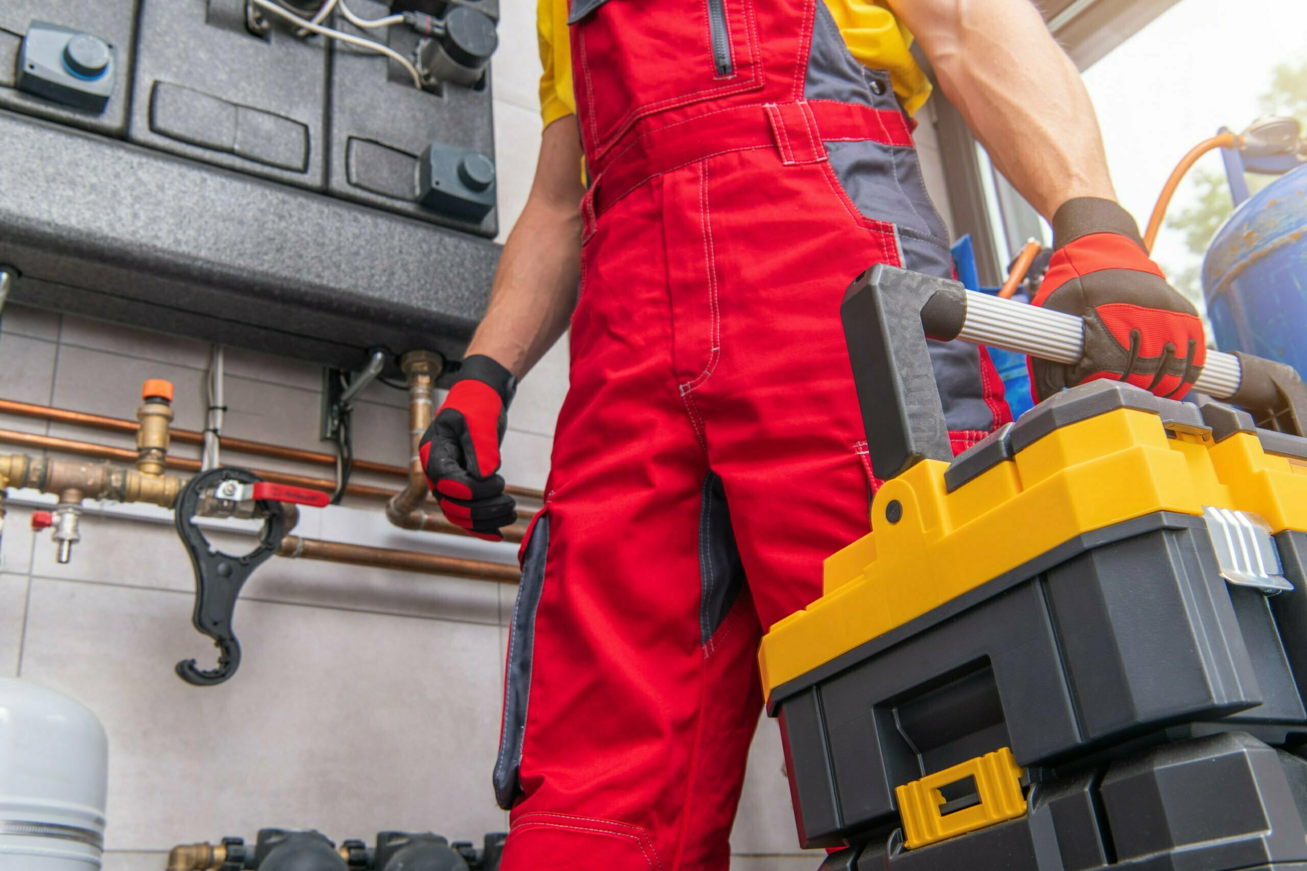 a person in a red suit working on a car