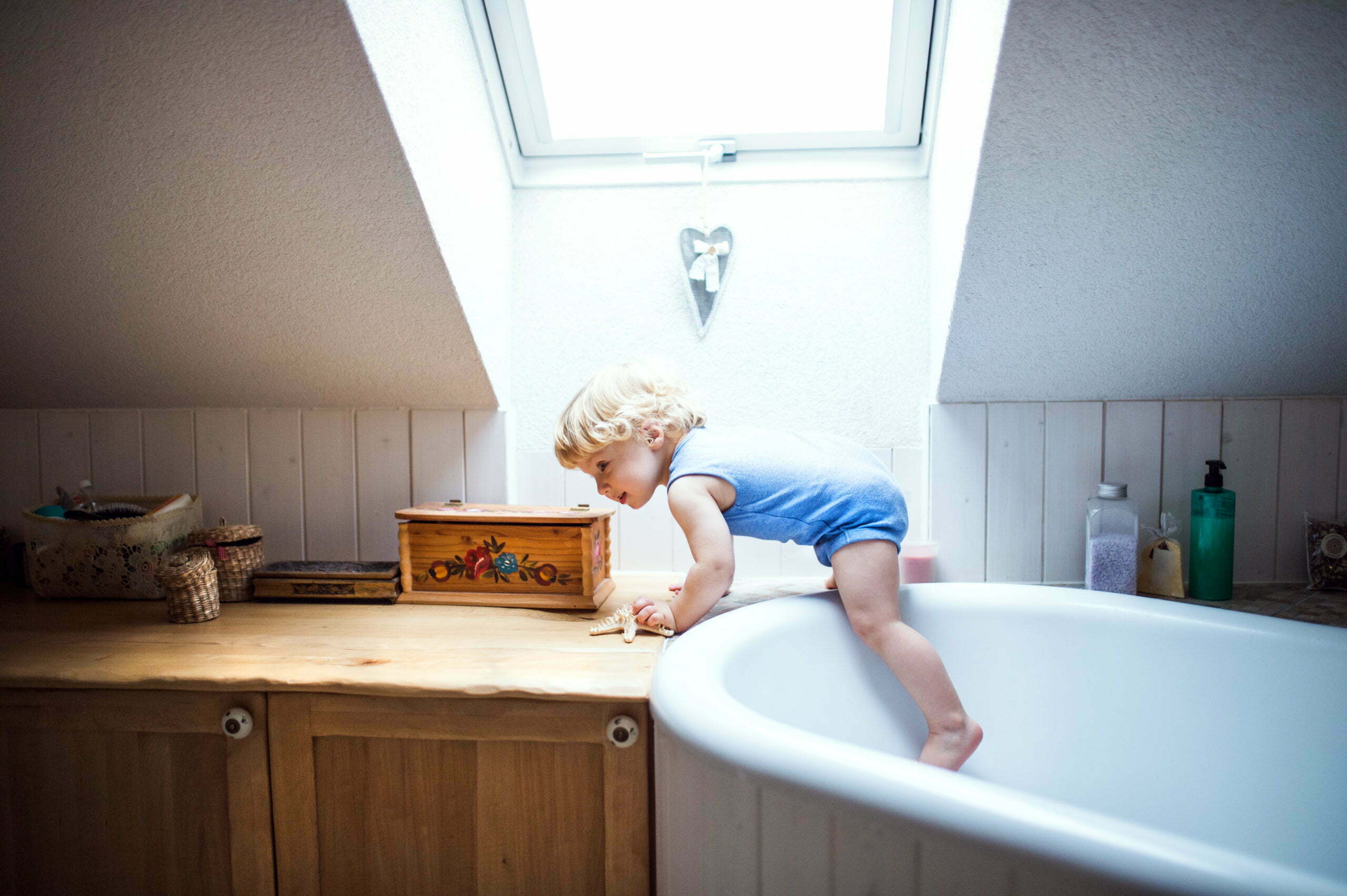 a child sitting on a bathtub